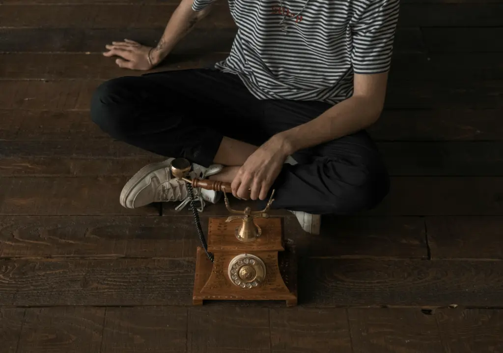 vintage phone and person dialing a number