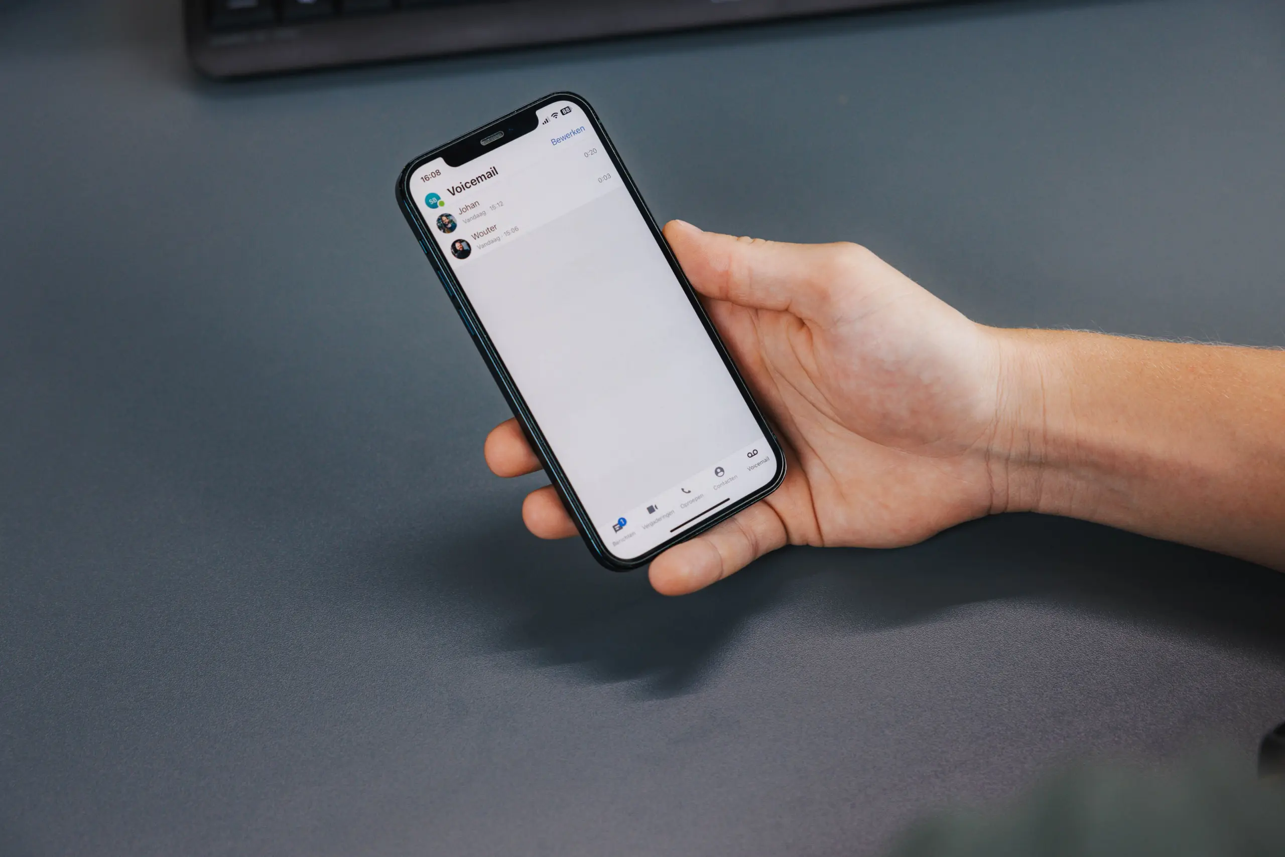 Hand holding a mobile phone with voicemail open